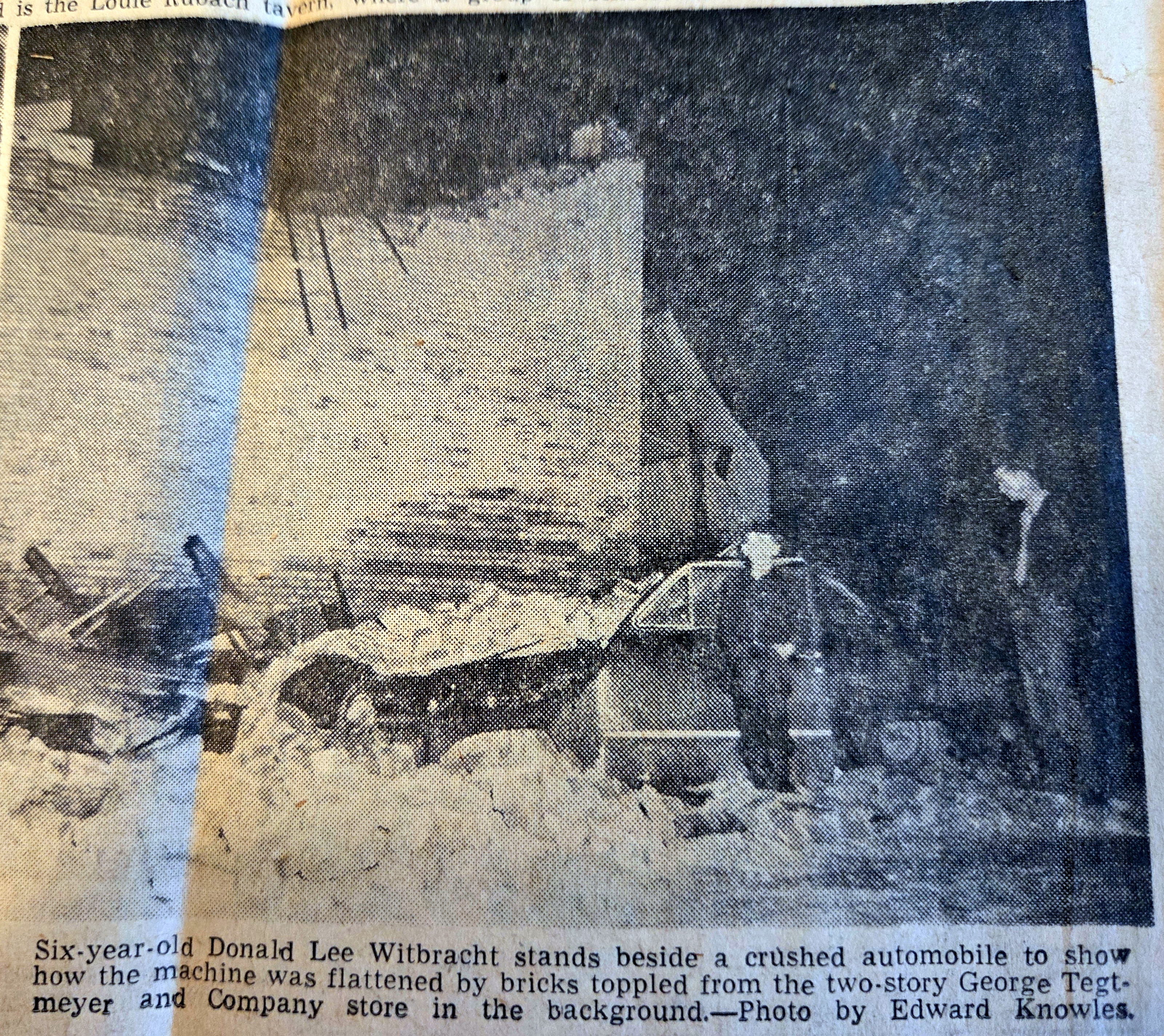 Crushed automobile beside Tegtmeyer store