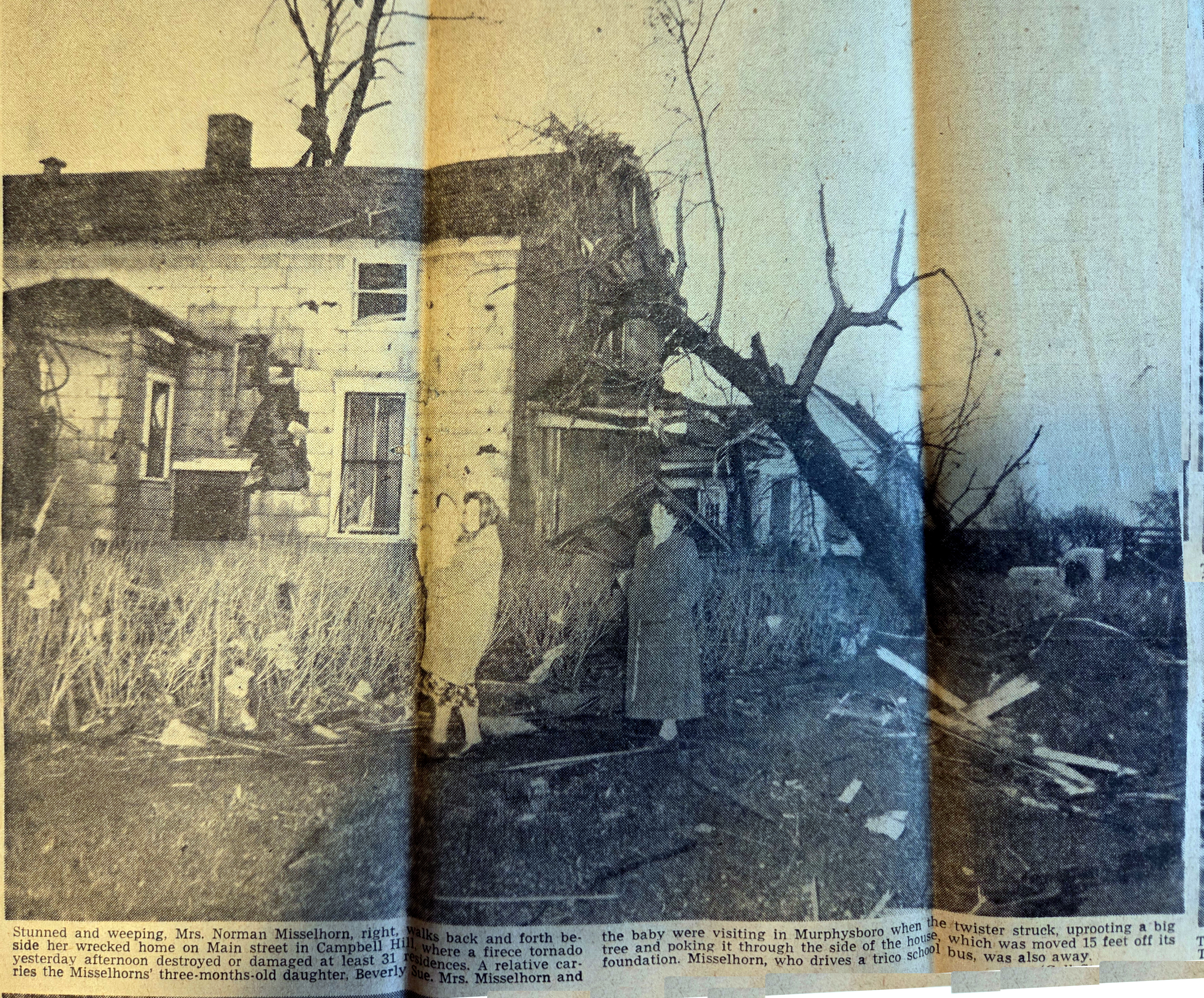 Mrs. Norman Misselhorn beside wrecked home